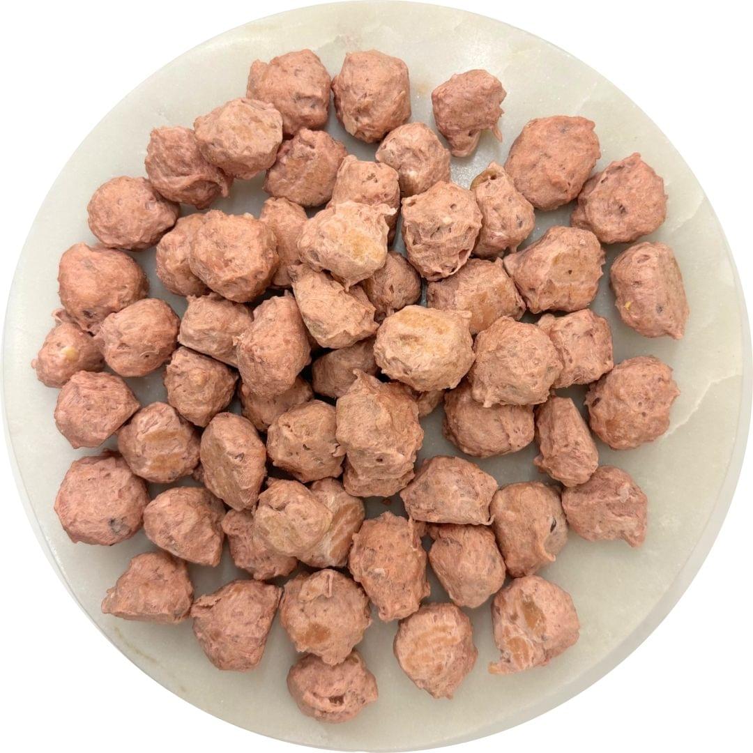 Chicken cheese cranberry dog treats in a round dish, featuring Chick’n Cheddar & Gouda Crunch bites.