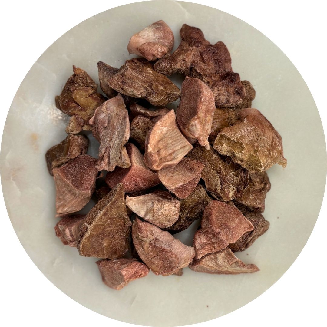 Picture of freeze dried chicken giblets on a white plate.