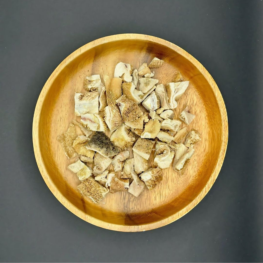 Green Lamb Tripe Dog Treats – Freeze-Dried pieces in a wooden bowl on a dark background.