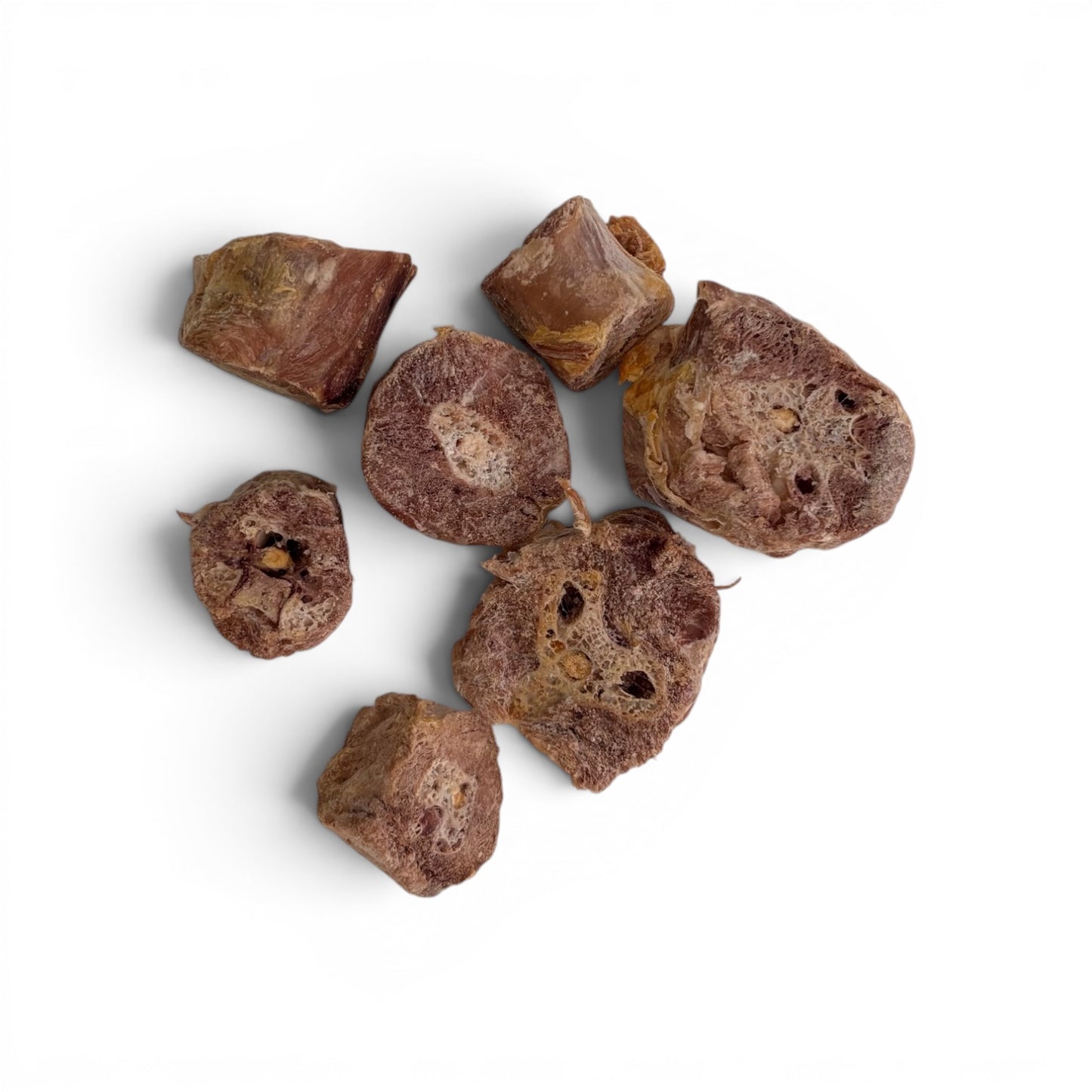 Pieces of Carnevere Mountain freeze dried turkey neck medallions  dog treats on a white background

